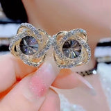 Gray zircon winding earrings, feminine temperament, light luxury, high-end silver needle earrings, popular Popular style ear jewelry in